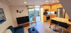 a kitchen with a couch and a table in a room at Intimate Townhome Sanctuary DT in Albuquerque