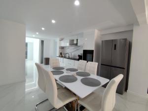 a kitchen with a table and chairs and a refrigerator at Mediterranean Stays Platinum in Alicante