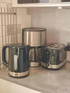 due caffettiere sedute su un bancone in cucina di Eerikinkadun Helmi a Salo