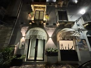a facade of a building with two doors at Casa del Pastaio in Catania