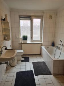 ein Badezimmer mit Badewanne, Toilette und Waschbecken in der Unterkunft Three bedroom lovely apartment in Oosterbeek