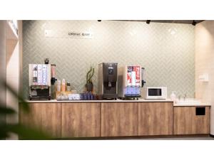 a coffee shop with a counter with a coffee maker at Hotel Taiyo Noen Saijo - Vacation STAY 26756v in Saijo