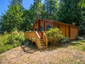 a small wooden cabin with a staircase in a yard at Sq Bayside Cedars in Sequim