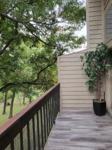 a porch with a potted plant on the side of a house at The Duke's Castle with Garage & Fast Internet in Dallas