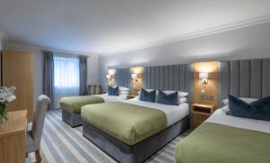 Posteľ alebo postele v izbe v ubytovaní Killarney Heights Hotel