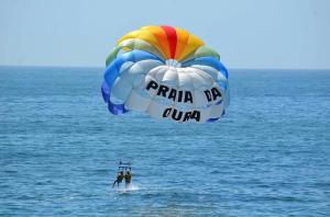 two people in the water with a parachute at Apartamentos Borda D´Agua in Albufeira