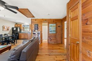 a living room with a couch and a kitchen at Heavenly Hideaway in Beattyville
