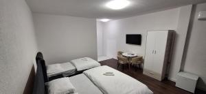 a small room with two beds and a table at Lakeside Haven in Plav