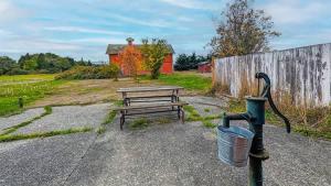 a picnic table with a bucket next to a fence at SQ The-Crab-Shack in Sequim