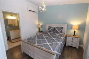 a bedroom with a bed and a chandelier at PA Hope Cottage in Port Angeles +7 photos