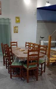 a dining room table with wooden chairs at Sports et détente in Fresse