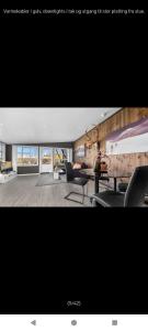 a living room with two chairs and a table at Ski inn Ski Out Best holiday Apartments i Oppdal in Oppdal