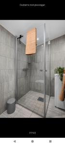 a shower with a glass door in a bathroom at Ski inn Ski Out Best holiday Apartments i Oppdal in Oppdal +36 photos