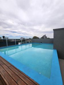 een zwembad op het dak van een gebouw bij Depto céntrico en Pinamar con parrilla y piscina en la terraza in Pinamar