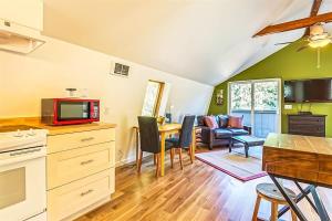 a kitchen and living room with a television and a table at Sqe Arcadian Grove in Sequim