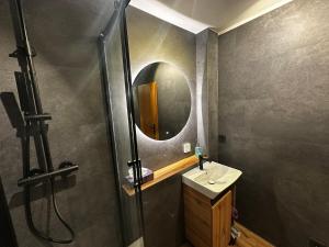 a bathroom with a sink and a mirror at Fächerlofts Black Forest Terrasse 40qm Studio WLAN - Messe Karlsruhe in Durmersheim