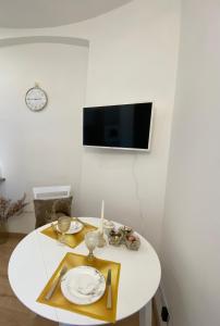 a white table with a candle and plates on it at Golden Rush in Riga +8 photos