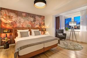 a bedroom with a large bed and a floral wall at Blumen(t)raum Ferienwohnung 2 in Karlsruhe