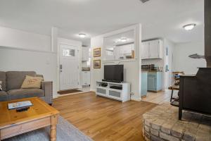 a living room with a couch and a tv at #StayInMyDistrict Cozy Rockaway Beach Cottage in Rockaway Beach