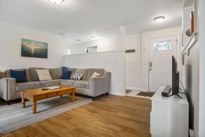 a living room with a couch and a tv at #StayInMyDistrict Cozy Rockaway Beach Cottage in Rockaway Beach