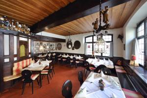 a restaurant with tables and chairs in a room at Brauereigasthof-Hotel Roter Ochsen in Ellwangen