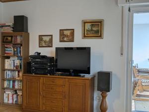 a living room with a television on a wooden dresser at Kaisers Ferienhof in Hallenberg