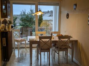 a dining room with a table and chairs and a window at Kaisers Ferienhof in Hallenberg