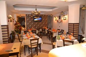 a restaurant with tables and chairs and a christmas tree at Porto Franco Residence in Brăila