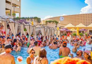 a crowd of people in the swimming pool at a resort at SAHARA Las Vegas in Las Vegas