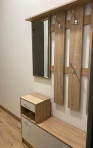 a dressing room with wooden cabinets and a mirror at Golden Rush in Riga