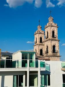 an old church with a steeple on top of a building at Hotel Gya Boutique in Aguascalientes