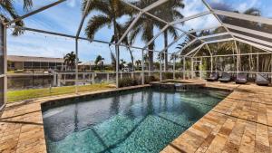 a swimming pool in a building with a glass house at NPL829 in Punta Gorda