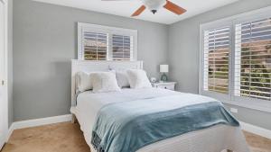 a bedroom with a bed with a ceiling fan at NPL829 in Punta Gorda +35 photos