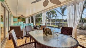 a patio with a table and chairs and a pool at NPL829 in Punta Gorda