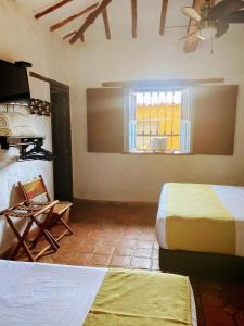 La Loma Hotel Barichara tesisinde bir odada yatak veya yataklar