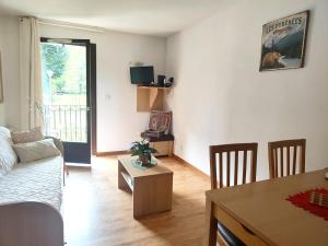 a living room with a couch and a table at Chez Soso in Luchon