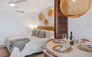 a bedroom with a bed and a table with wine glasses at Sea La Vie at Sapphire Beach Resort & Marina in East End