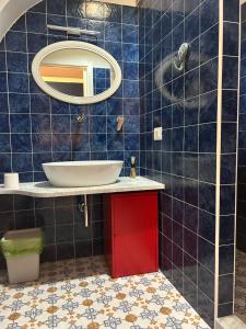 a bathroom with a sink and a mirror at Cappuccino Apartment Sorrento in Sorrento