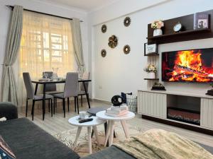 a living room with a fire on the wall at Casa Bellà Game View in Nakuru