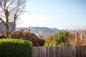 a wooden fence in front of a city with buildings at L'escapade colorée - gare - Futuroscope - parking in Poitiers