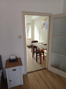 a kitchen and dining room with a table and a dining room at City-Apartman in Kaposvár +2 photos