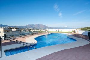 a swimming pool on the roof of a building at Blue Sunset Retreat in Manilva