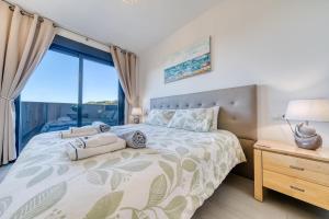 a bedroom with a large bed with a large window at Blue Sunset Retreat in Manilva +33 photos