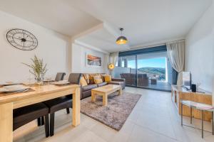 a living room with a couch and a table at Blue Sunset Retreat in Manilva