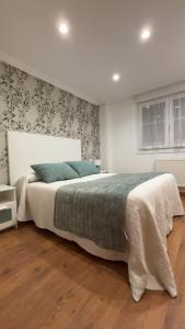 En eller flere senge i et værelse på Apartamento Fana