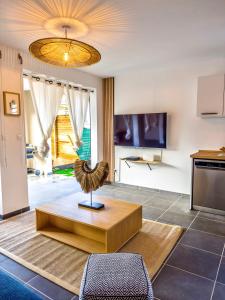 a living room with a couch and a table at Evasion tropical in Les Trois-Îlets