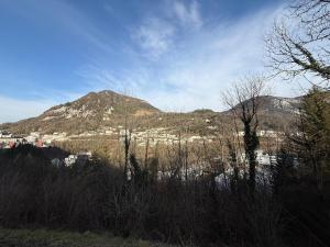 a view of a mountain with a city and a town at Appartement moderne avec jardin, quartier calme in Saint-Claude