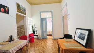 a room with two tables and chairs and a window at Ala do castelo hotel in Lagos