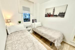 a bedroom with a bed and a bench and a window at MARBELLA ALICATE BEACHFRONT - Luxury Apartment-1 in Marbella +47 photos