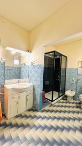 a bathroom with a shower and a sink and a toilet at Ala do castelo hotel in Lagos +30 photos